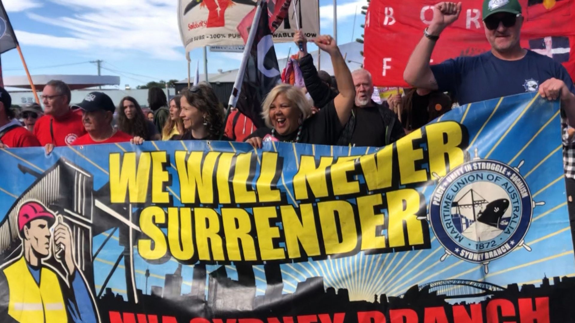 Maritime Union of Australia protest against AUKUS. Community march with colourful banners.