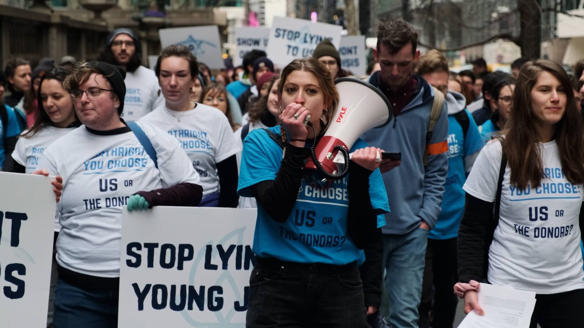 Film still of young people protesting