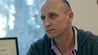 Film still of man looking somber and off camera